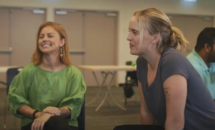 Female facilitator and client smiling