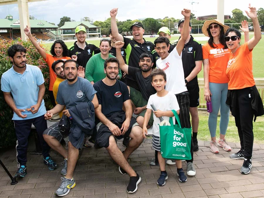 Group of newcomers and SSI volunteers happy together