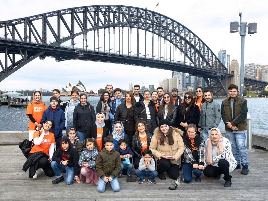 Group posing in front of Harbour Bridge in Sydney