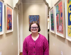 Bridget in the hallway of her family home which was converted into a gallery, her artworks are hanging on the walls
