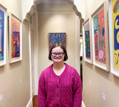 Bridget in the hallway of her family home which was converted into a gallery, her artworks are hanging on the walls
