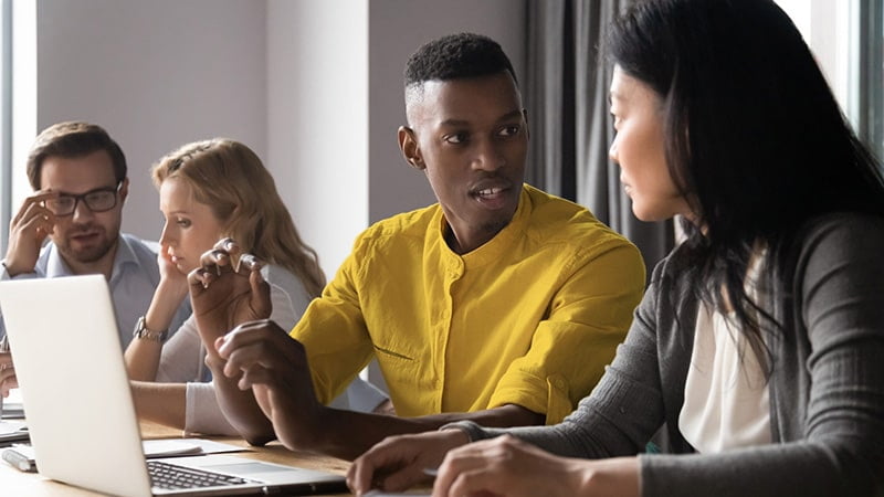 Male participants of SSI's Skilling Queenslanders for Work program sits at desk working