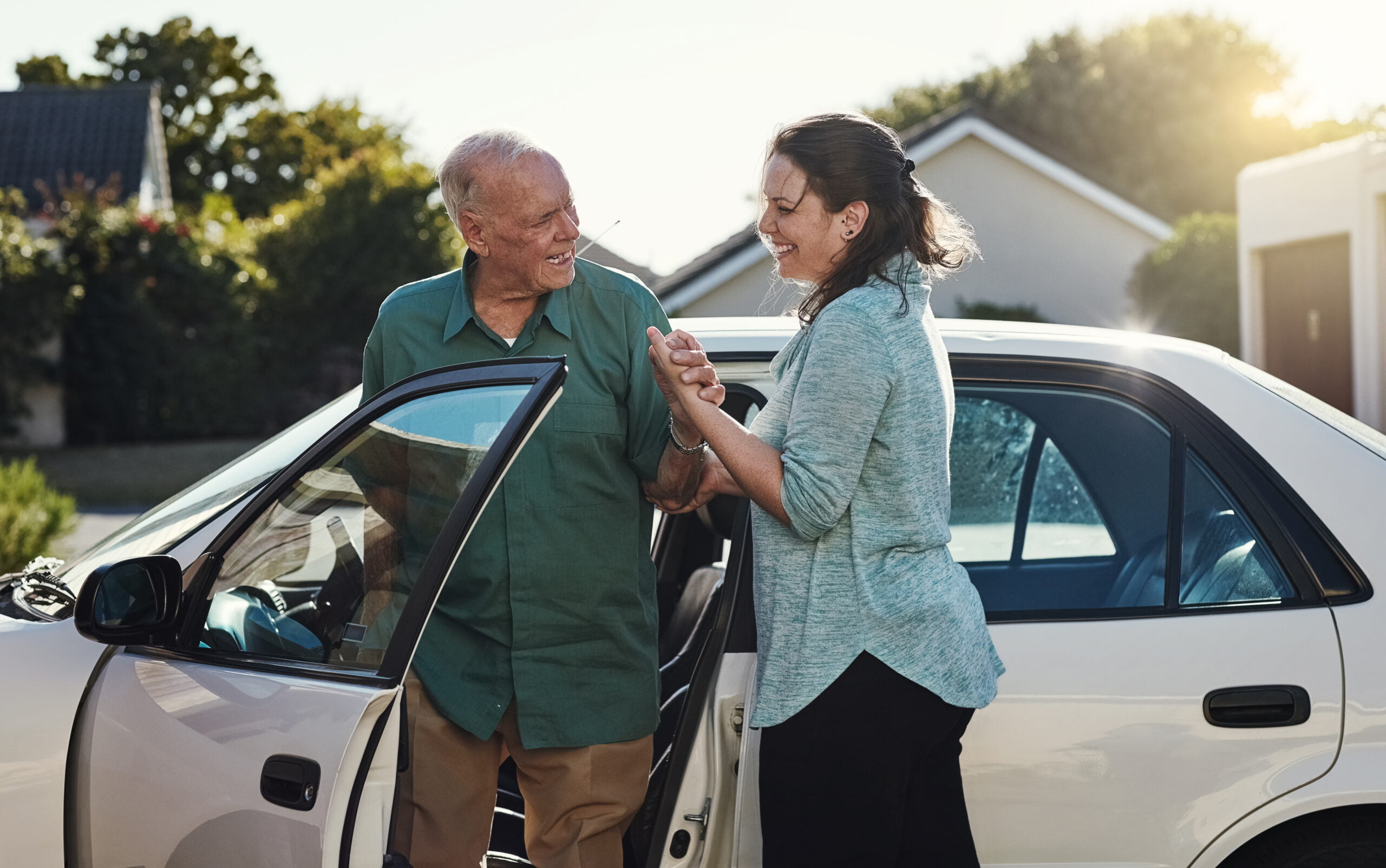 Home care worker helping senior out of car
