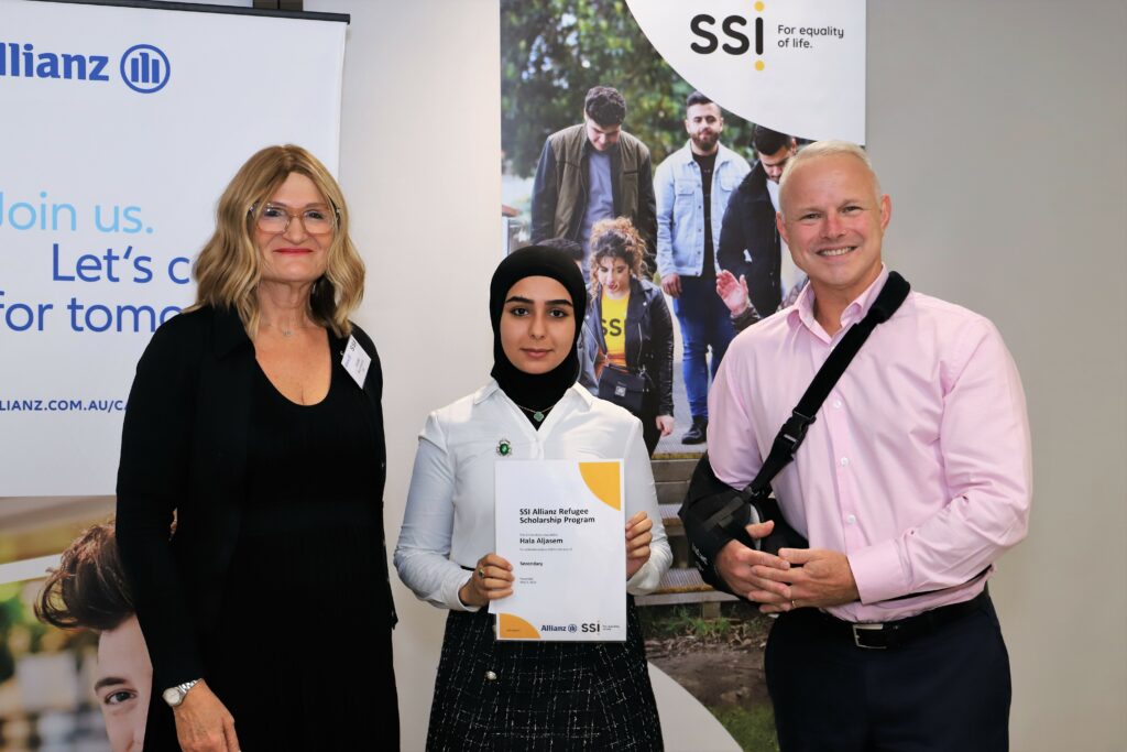 Hala receiving her certiciate from SSI CEO, Violet Roumeliotis, and Allianz Australia Managing Director, Richard Feledy