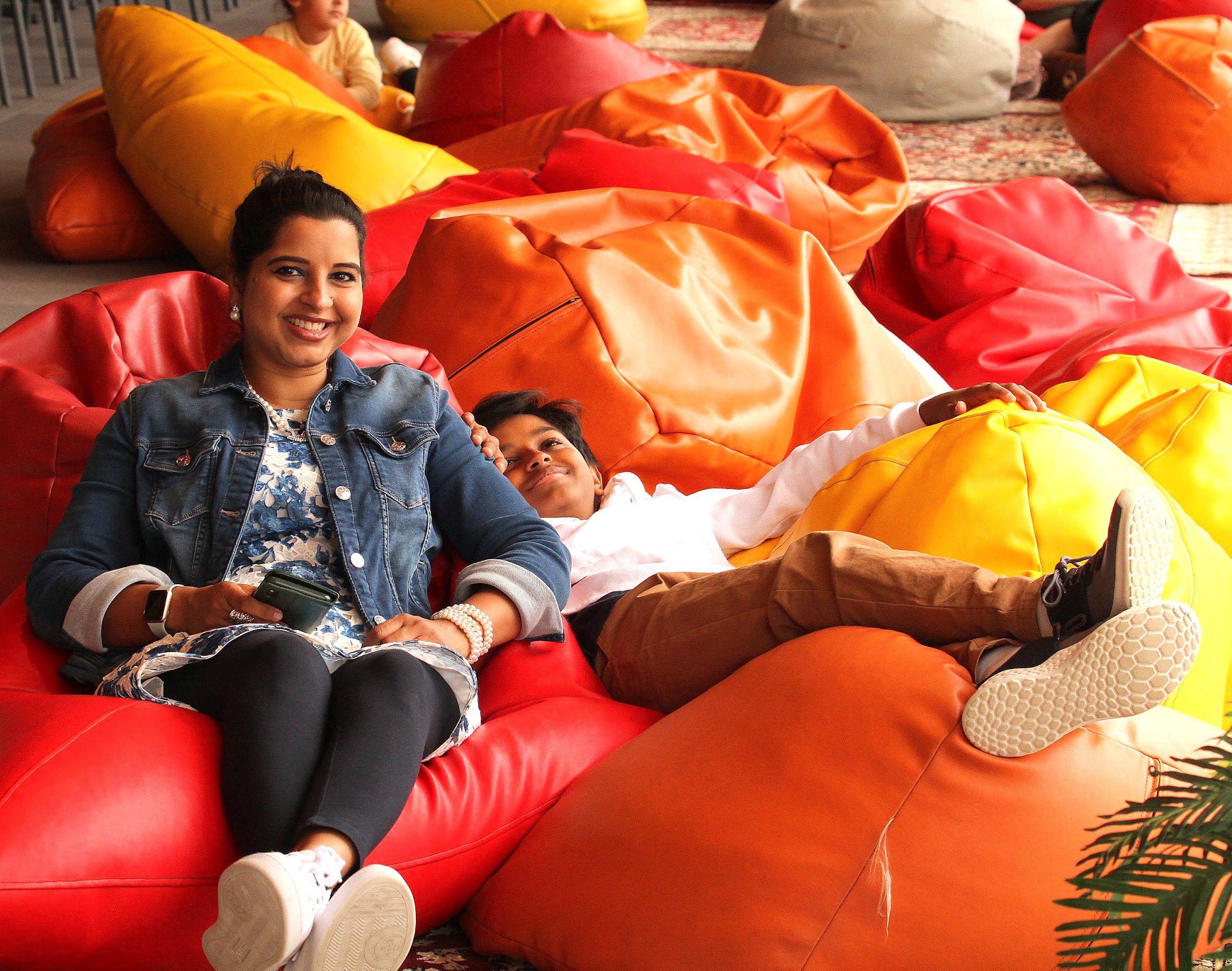 Happy mum and son lounging on beanbags