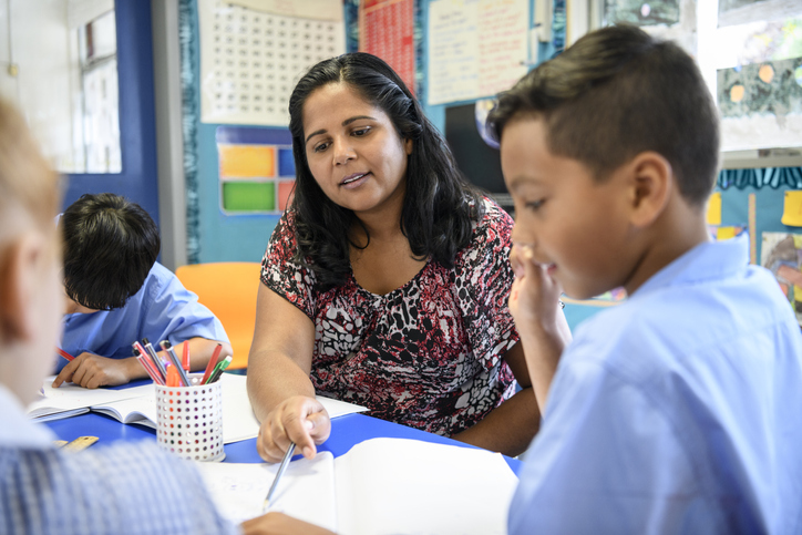 Australian female support worker with children offering support and guidance