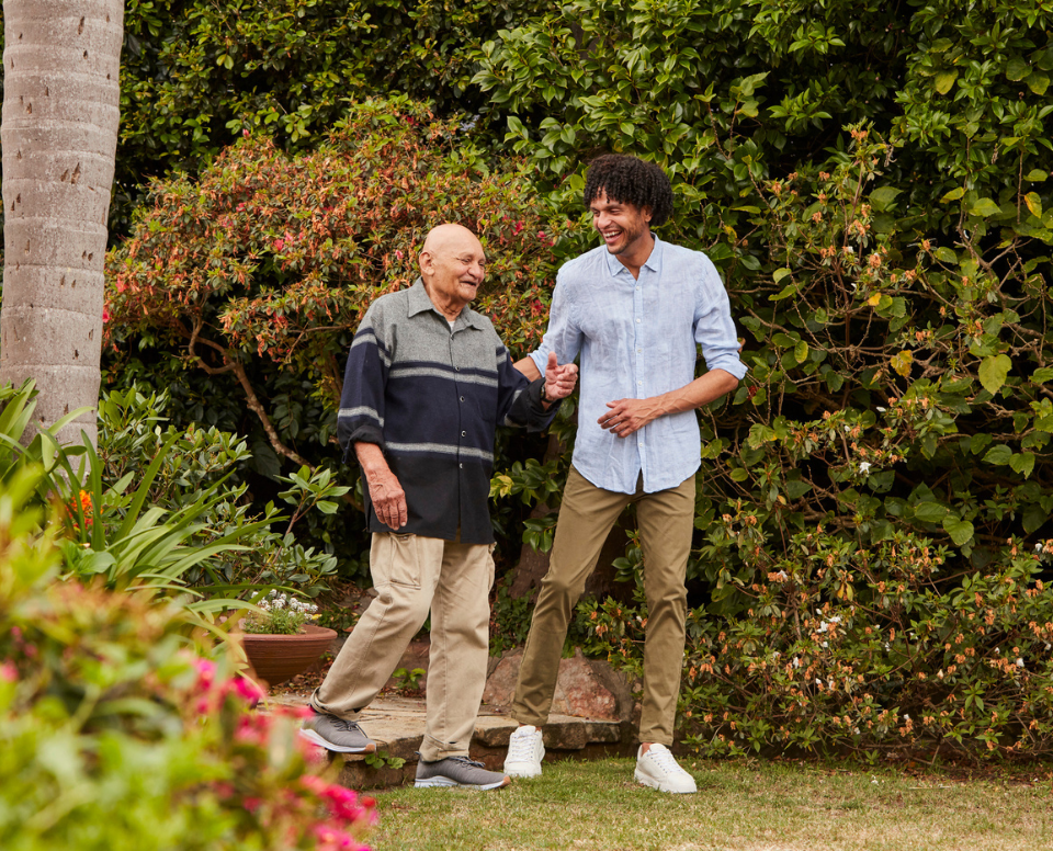 A young man and a old man have fun in a garden