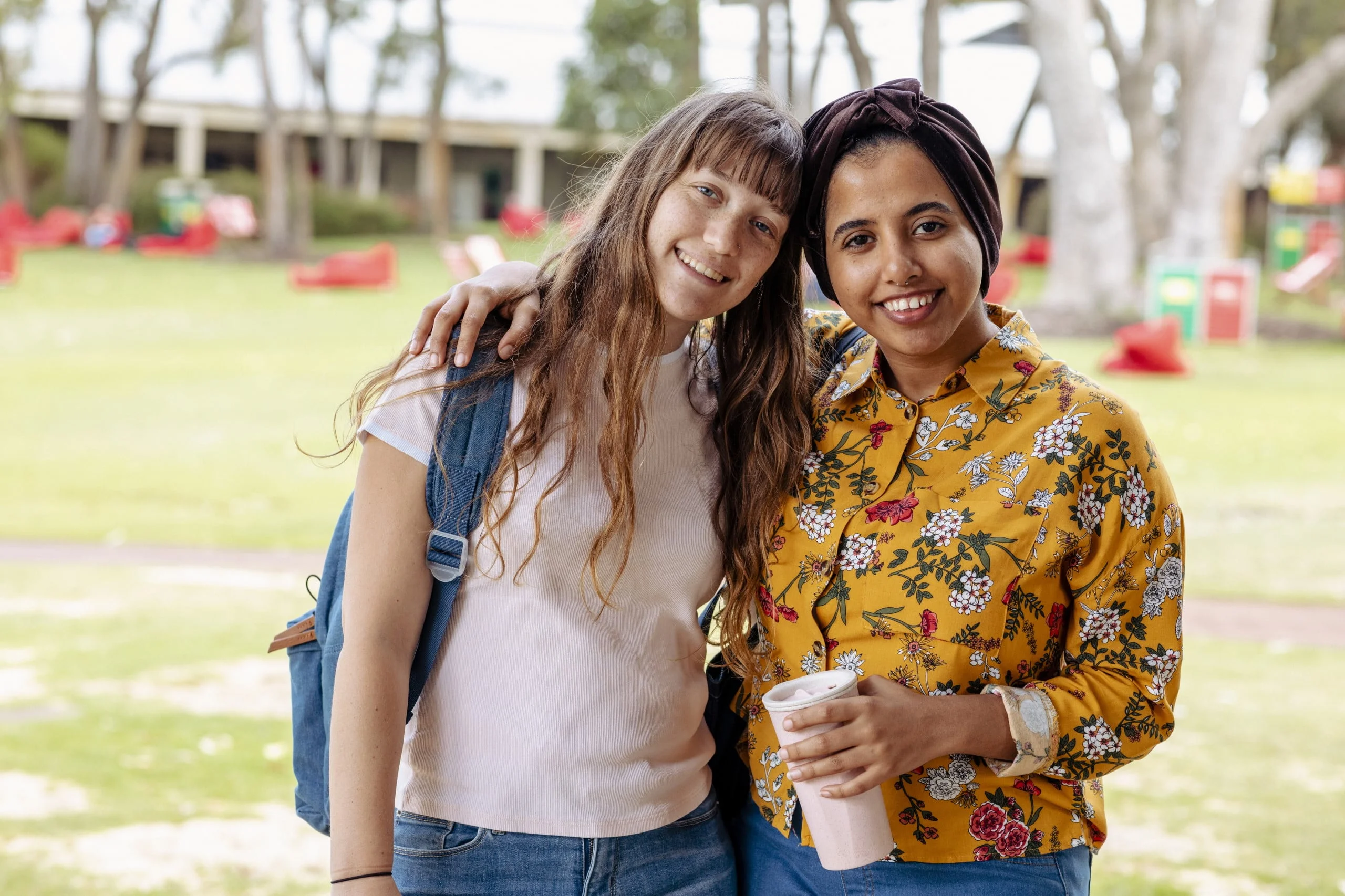 Women working together and hugging for picture