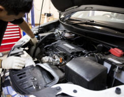 SSI LAC participant, Charlie, working on a car in garage