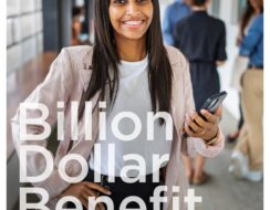 Young professional holds up her mobile phone and smiles at the camera