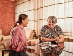 Two people sitting down at a table discussing home care