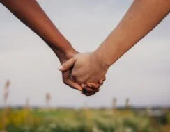 Two women holding hands
