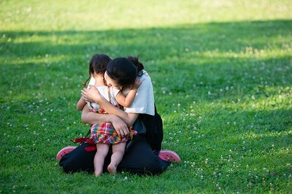 Woman hugging a small child in the park
