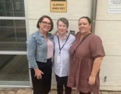 Women standing in front of building