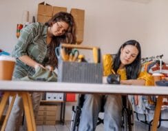 two women in the workplace, one woman is in a wheelchair