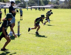 School kids running and playing cricket