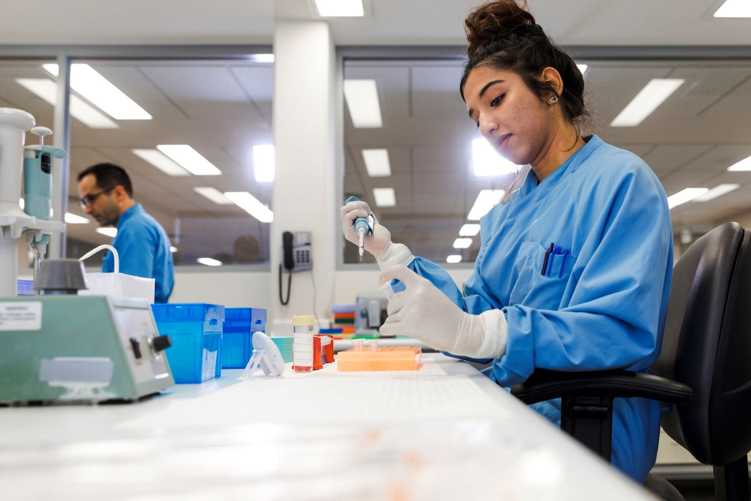 Skilled lab worker conducting experiment.