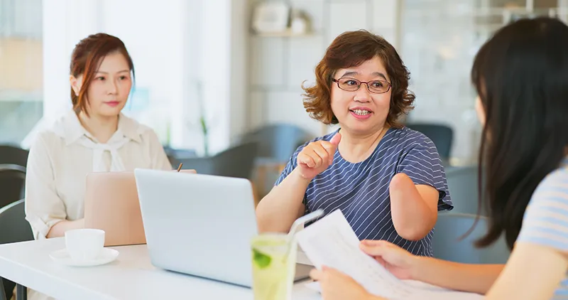 Woman with a disability leading a team meeting