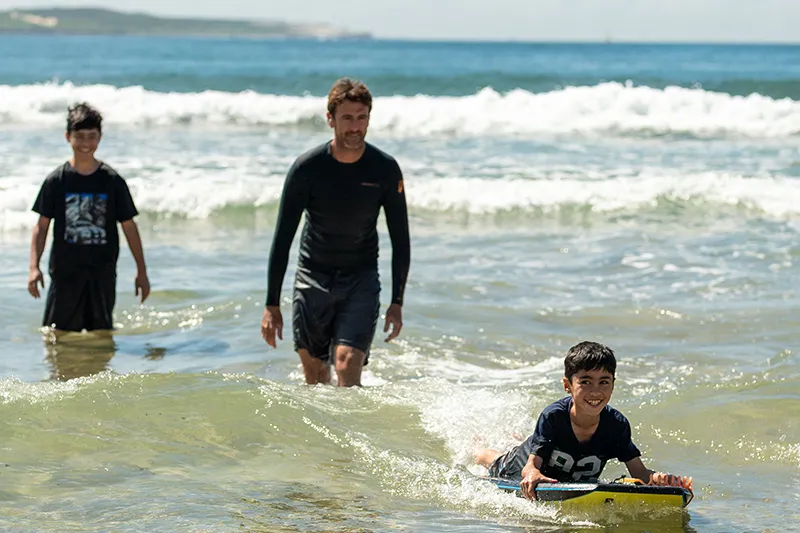 Young child riding a wave at the beach