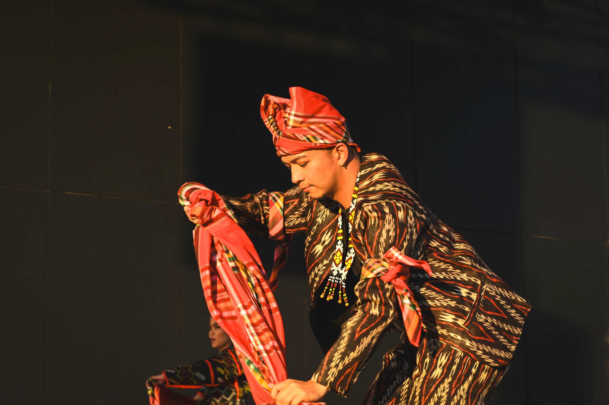 A male performer is on stage at World of Cultures 2025