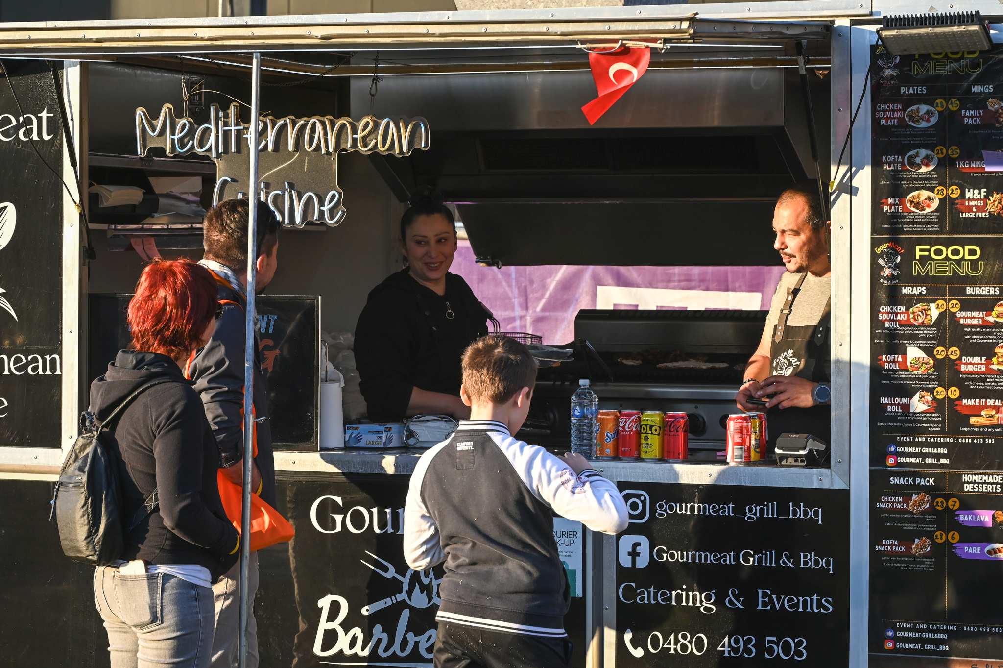 Guests at World of Cultures buy food from a food truck