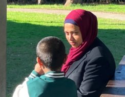 Mother sitting in the park with her son.
