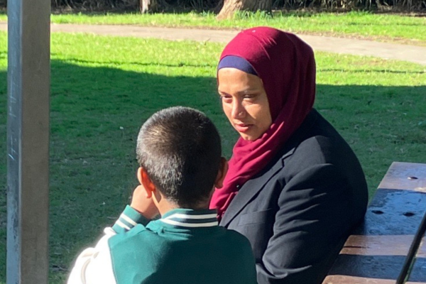 Mother sitting in the park with her son.